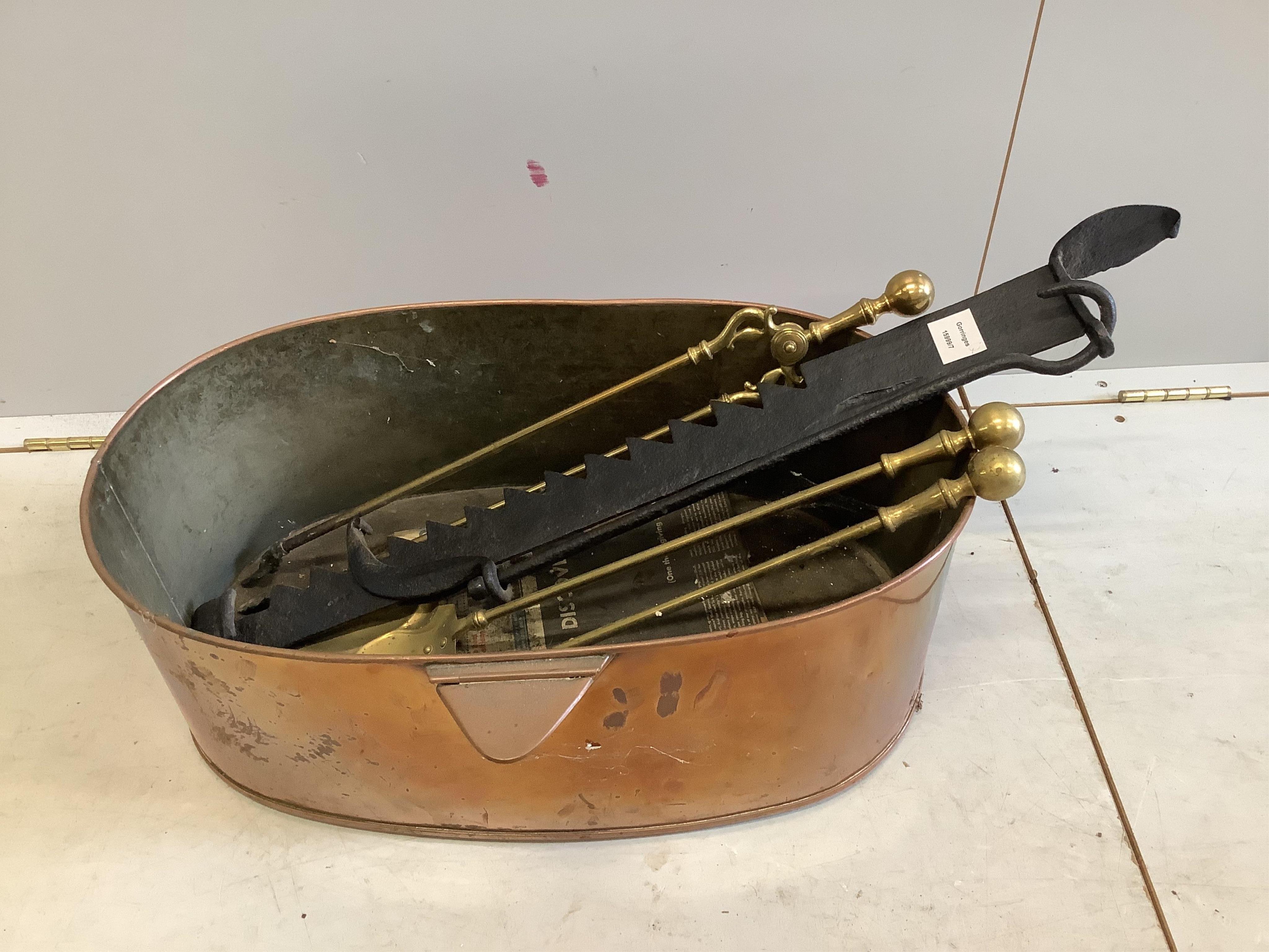 A Victorian oval copper container, width 61cm, depth 40cm, height 22cm, together with three brass fire implements and a roasting jack. Condition - fair